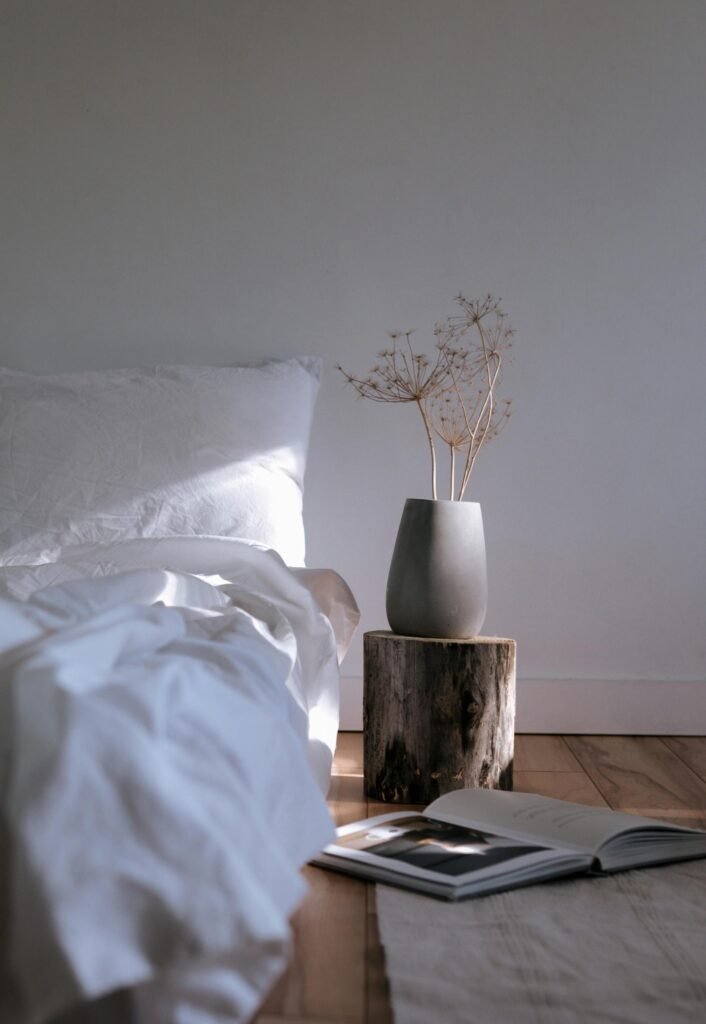 Japanese minimalism - a vase with dried flowers on a stump next to a book