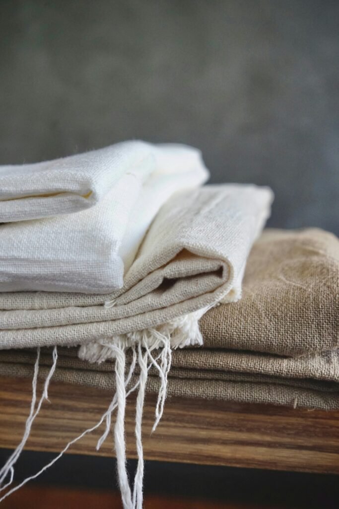 wabi-sabi - a stack of white and brown linen blankets