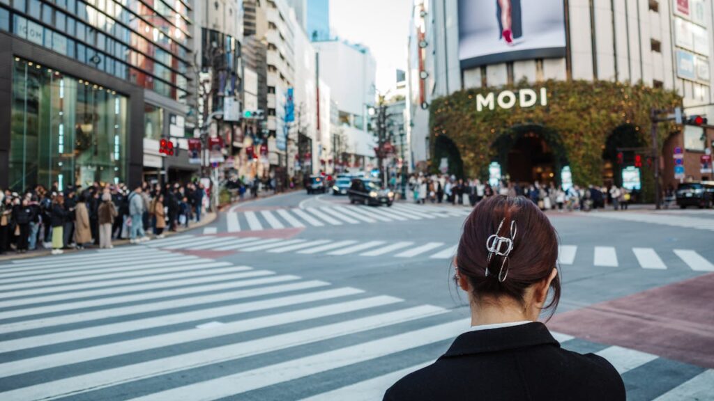 Shibuya streetscape with neon signs and fashion stores in central Tokyo